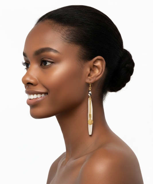 Woman wearing a gold and white earring on a white background