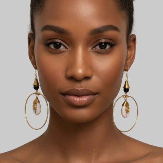 Woman wearing gold hoop earrings with a neutral background