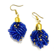 A pair of blue and gold beaded drop earrings with a gold-tone cap and hook closure.