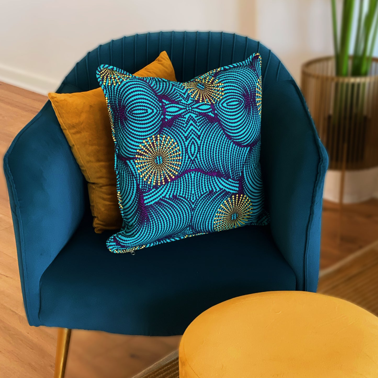 A colorfully patterned blue and yellow pillow case cover sitting in an arm chair.