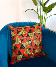 Decorative pillow with geometric pattern on a blue chair