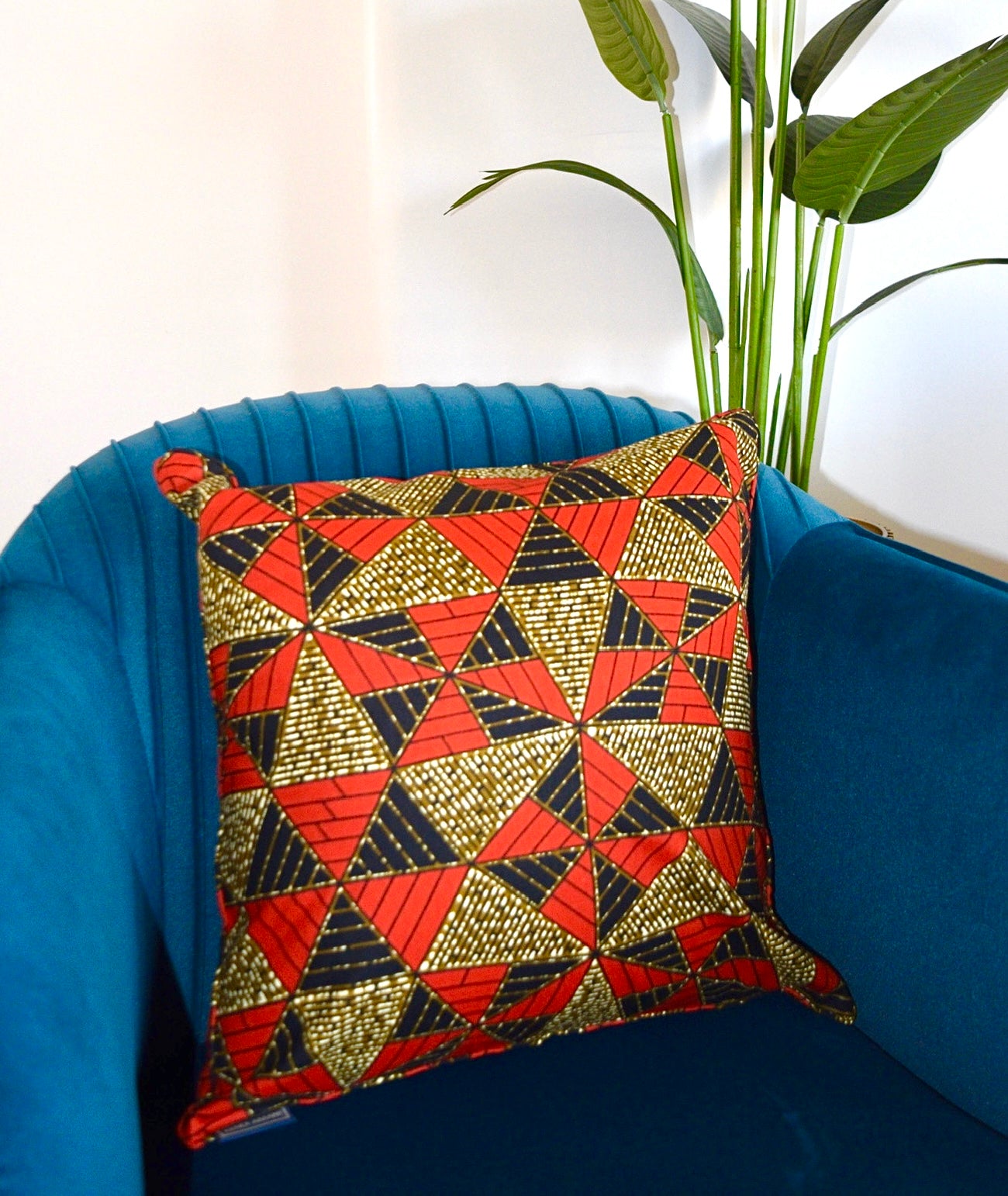 Decorative pillow with geometric pattern on a blue chair