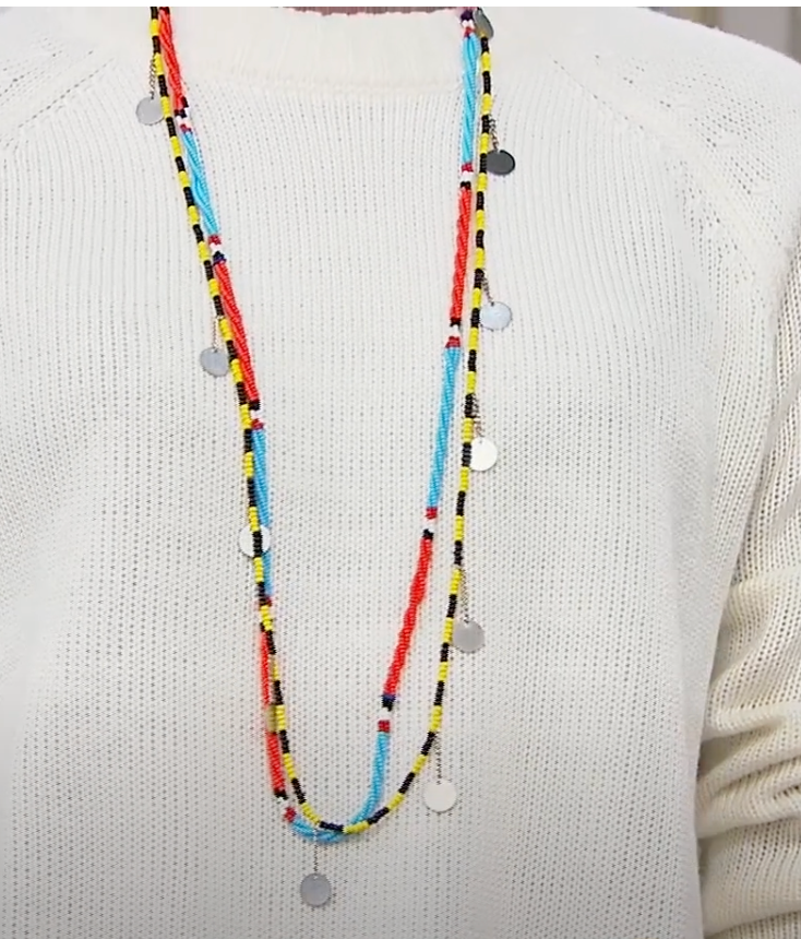 Colorful beaded necklace on a white sweater