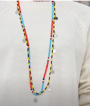 Colorful beaded necklace on a white sweater