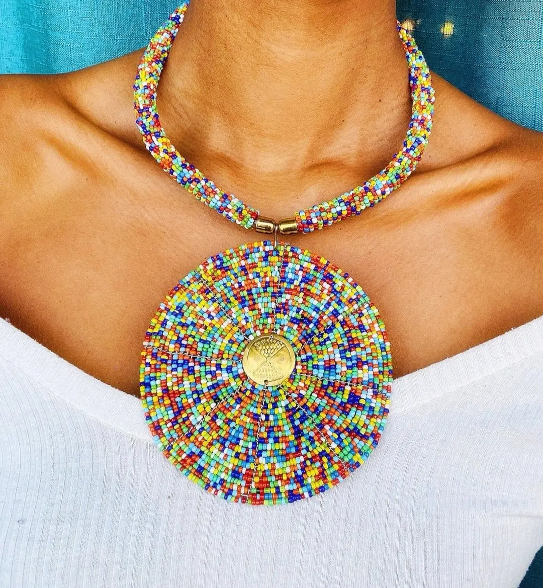 A woman wearing a multicolored circular beaded necklace.