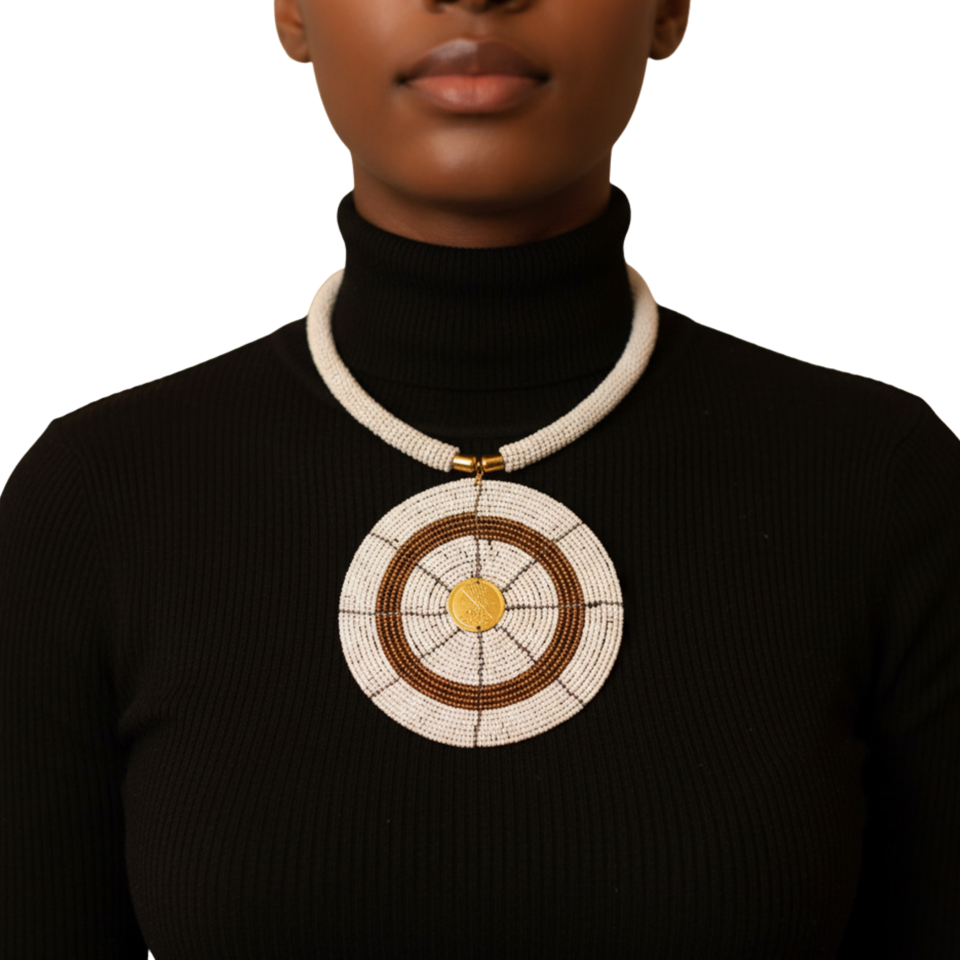 Person wearing a black turtleneck with a large decorative necklace on a white background