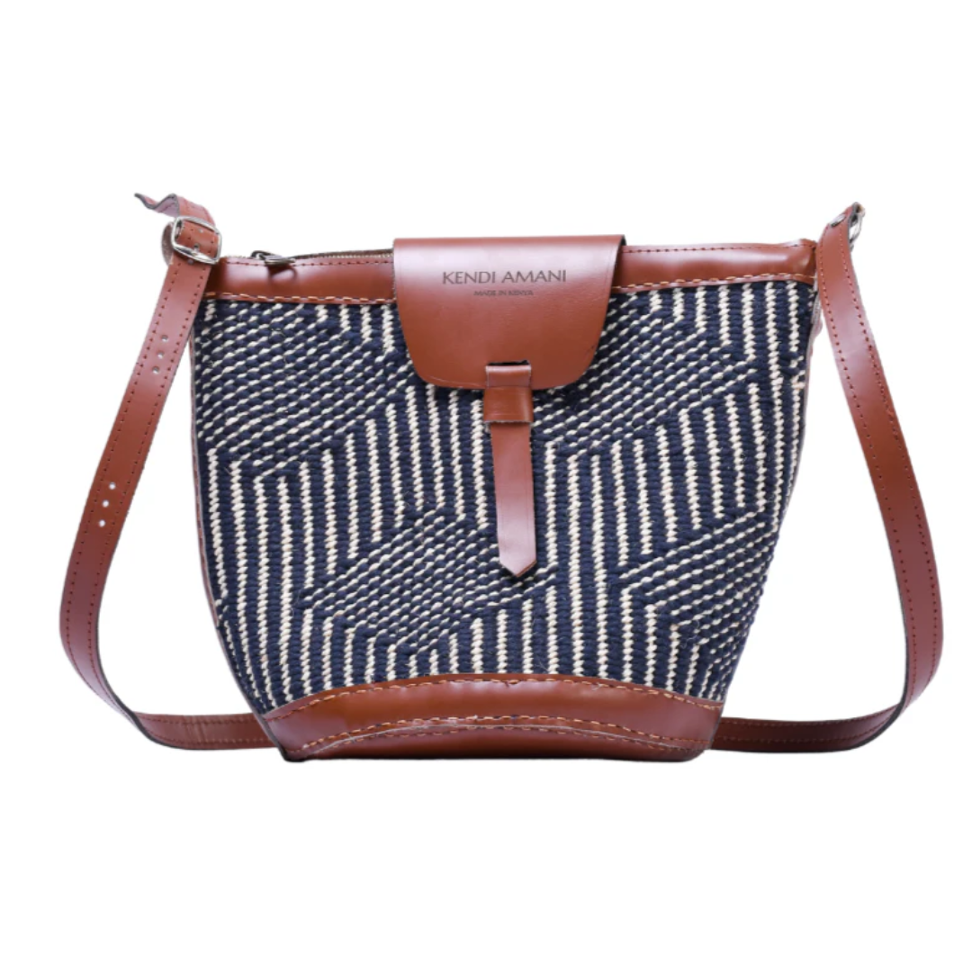 A black and white wool woven bag with leather accents on a white background.