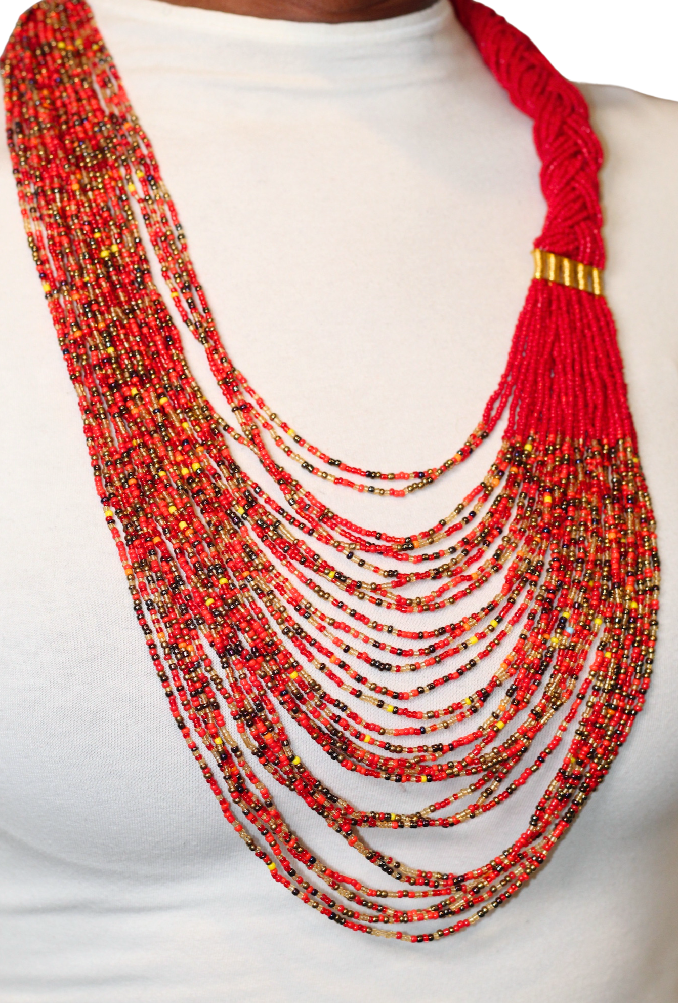 A woman wearing a red braided beaded necklace with black, gold, and yellow accents.