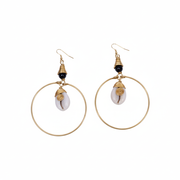 Gold hoop earrings with white stones and black beads on a white background