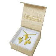 A jewelry box containing a gold necklace and a pair of matching golden earrings. Each jewelry displays the shape of Africa.