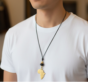 Man wearing a white t-shirt and necklace with a pendant indoors