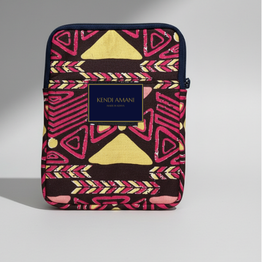 Colorful patterned pouch with 'Kendi Amani' branding on a gray background