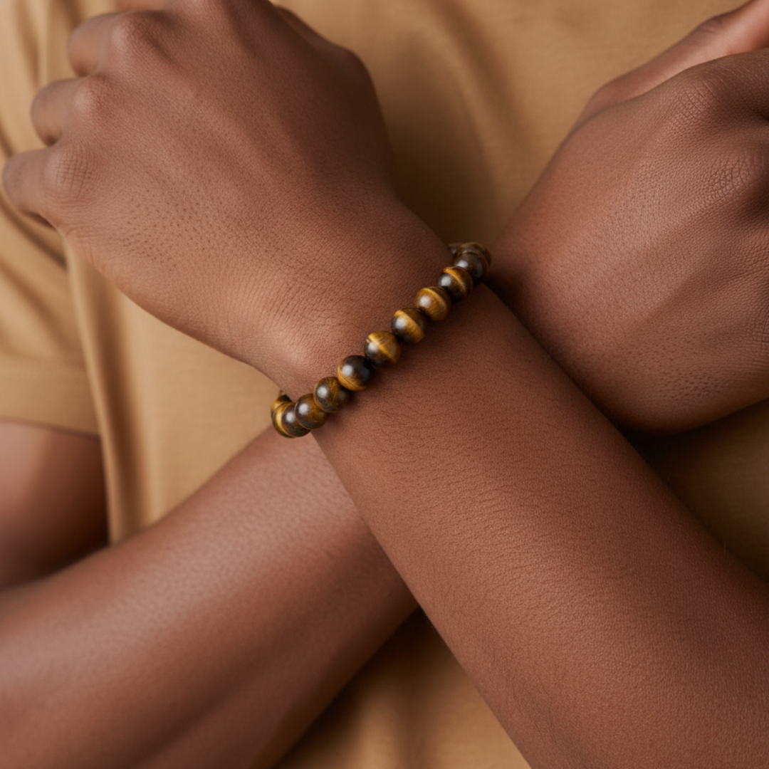 Close-up of a wrist wearing a tiger eye bracelet