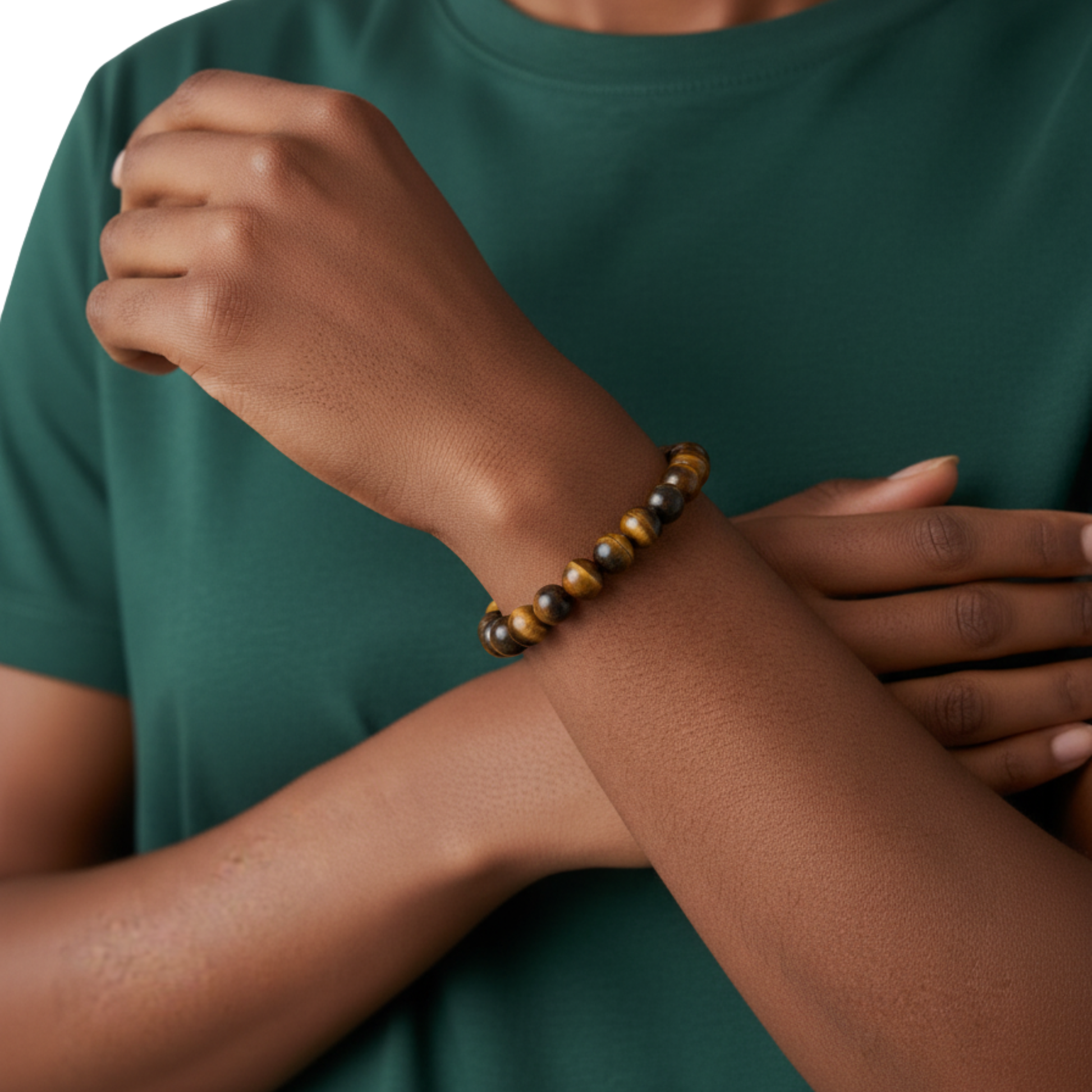 Person wearing a tiger eye bracelet on a green shirt background