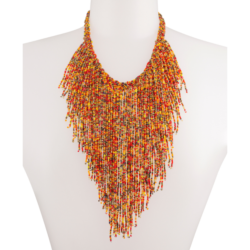 A mannequin wearing an orange beaded necklace accented with various colorful beads like red, yellow, and gold.