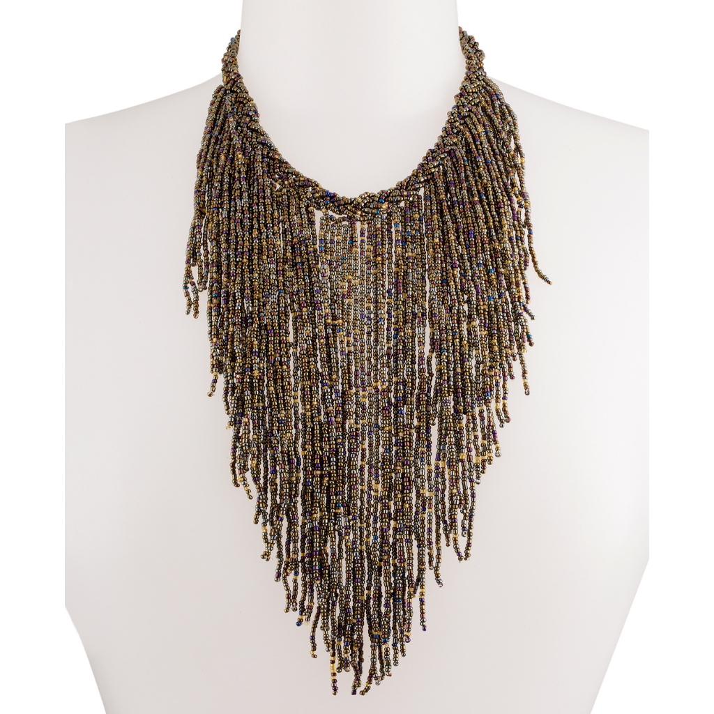 A mannequin wearing an brown beaded necklace accented with various beads of yellow and gold.