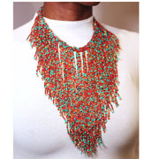 A woman wearing an multicolored beaded necklace with gold accents.