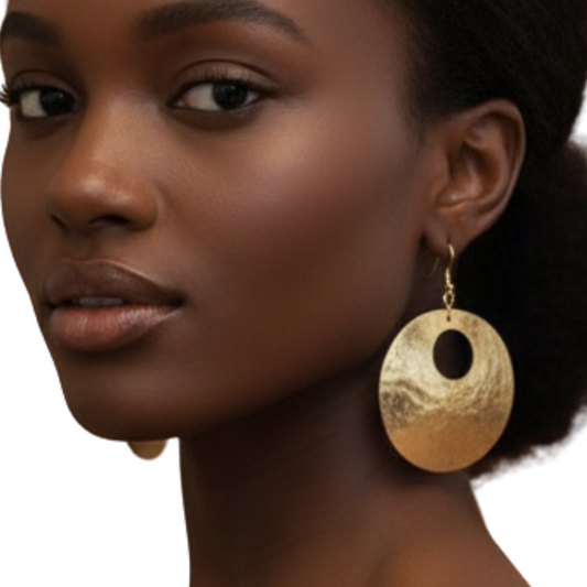 Woman wearing gold earrings on a white background