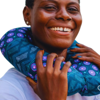 A lady using a blue neck pillow with purple accents