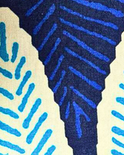 A close-up of a textured fabric with a blue and white pattern