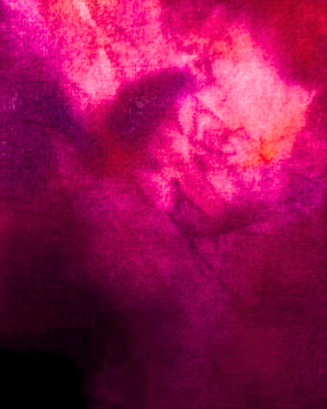 Close-up of a textured pink fabric with a heart shape.