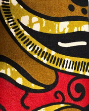 A swatch of a colorful fabric pattern with red, yellow, and black colors.