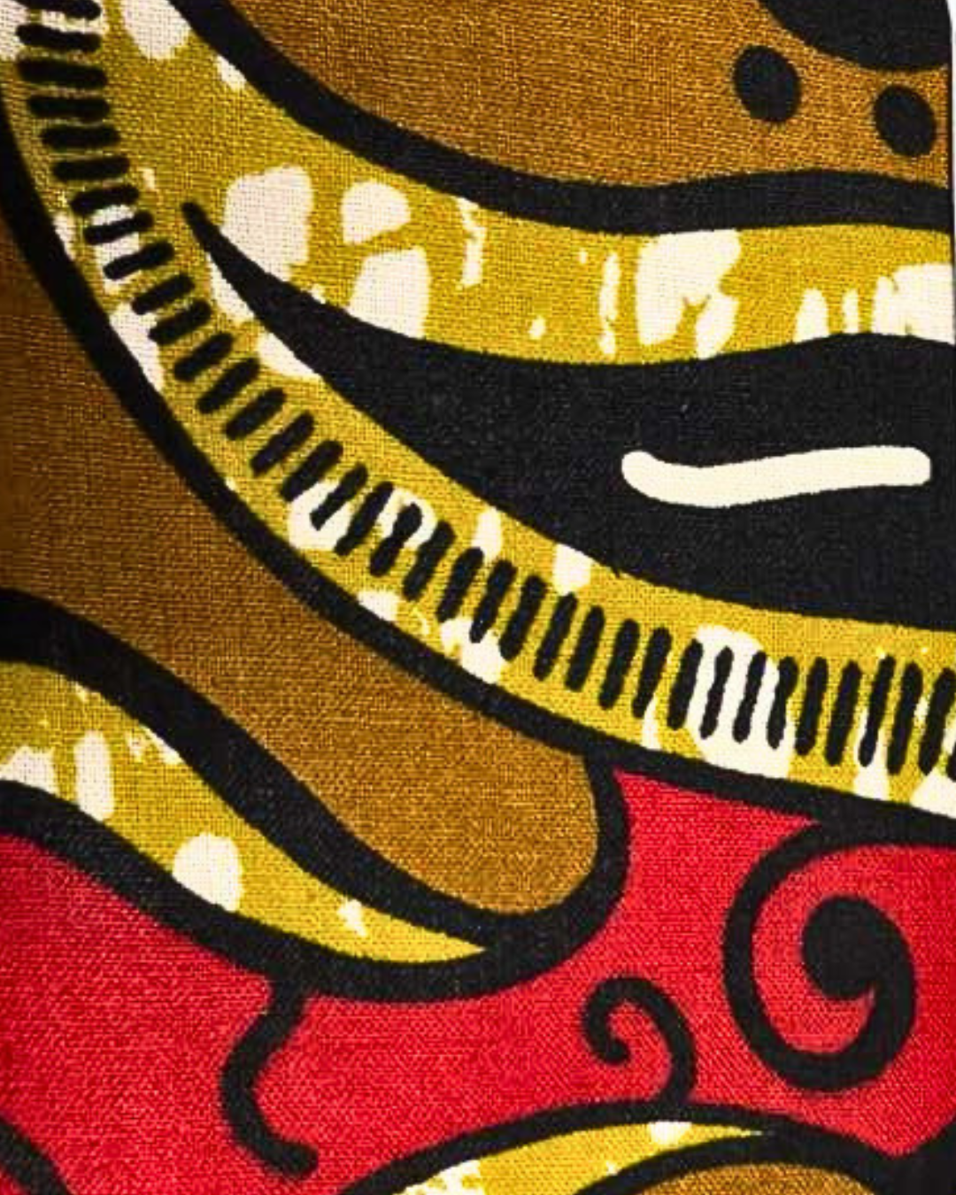 A swatch of a colorful fabric pattern with red, yellow, and black colors.