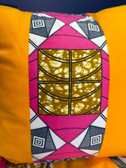 Decorative pillow with geometric pattern on a yellow background