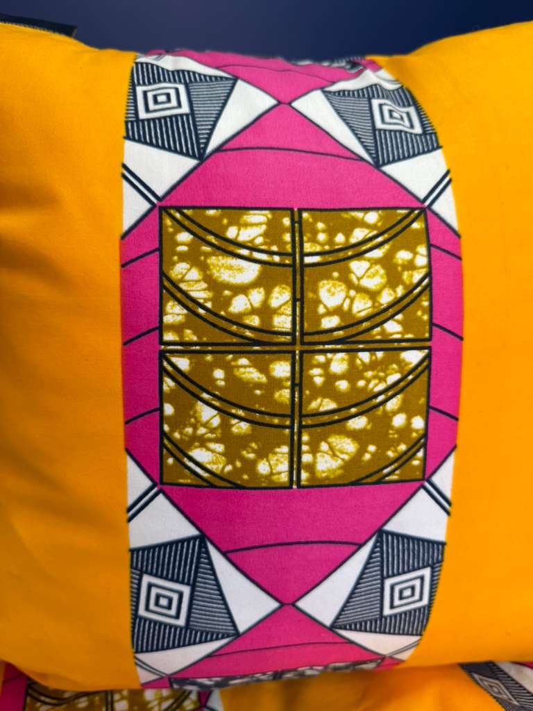Decorative pillow with geometric pattern on a yellow background